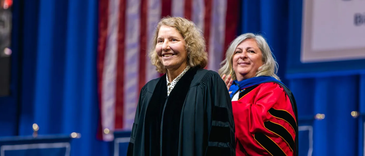 UNE Provost Gwen Mahon prepares to hood retired Lt. Gen. Michelle Johnson with an honorary Doctor of Humane Letters