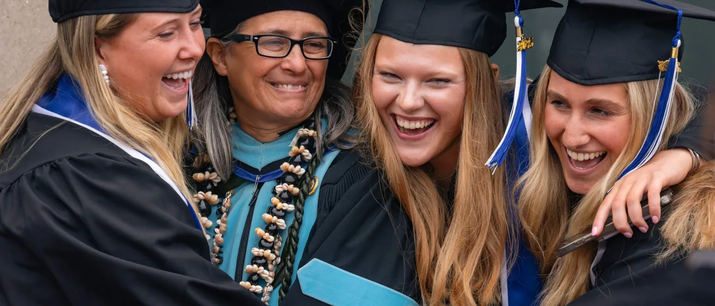 Students celebrate in a photo outside the Cross Insurance Arena