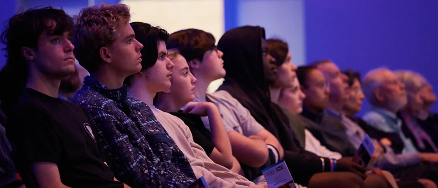A row of students listening intently at a lecture