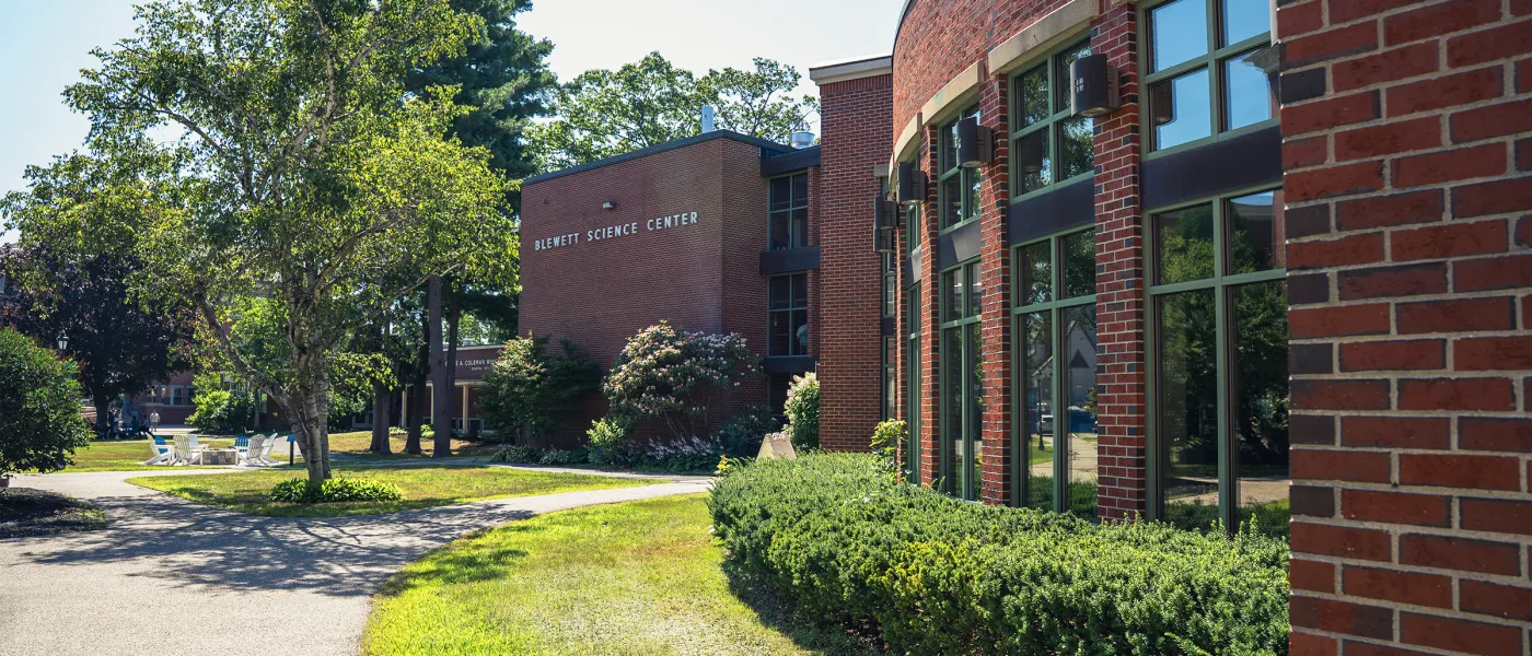 A brick building with a row of large windows