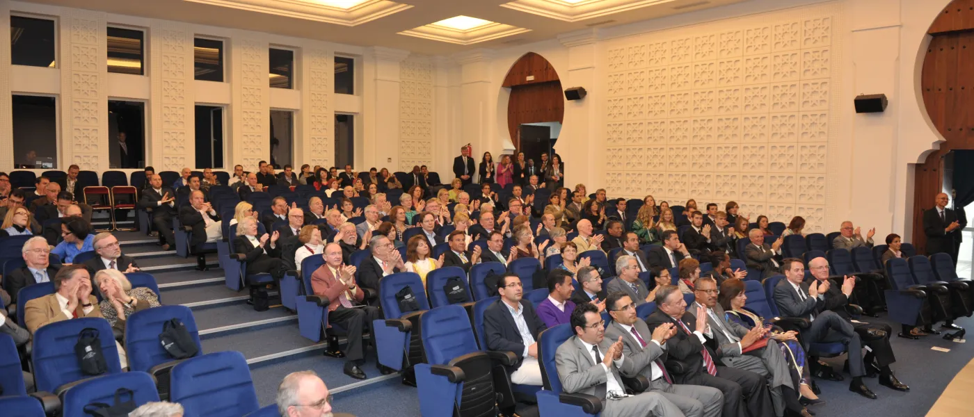 A full house in the campus theatre for the opening dedication ceremony for U N E Tangier.