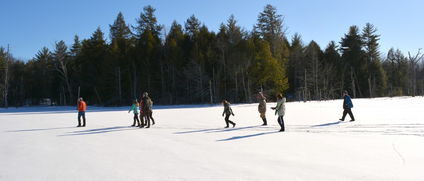 U N E students explore a snowy field