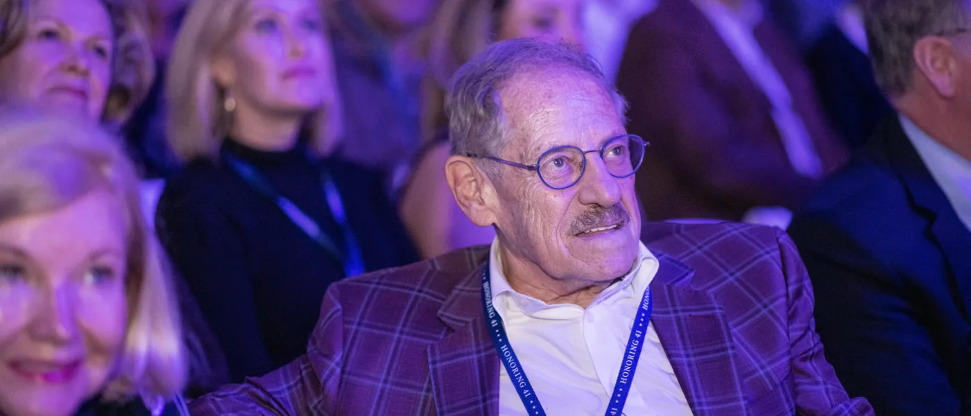 A male audience member watches the Bush lecture