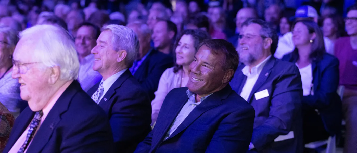 Audience members watch the Bush lecture