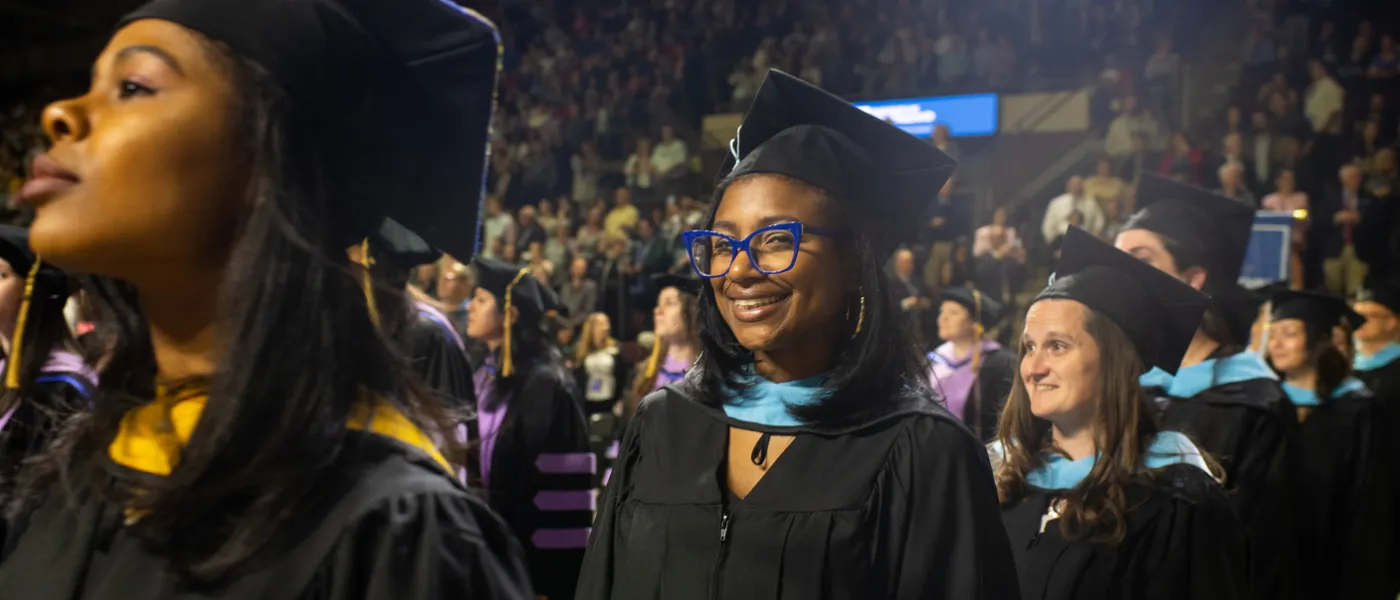 Students stand at graduation