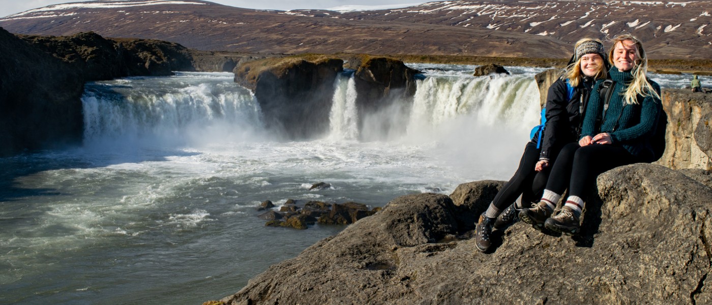 Students near a waterfall in Iceland during Travel Course