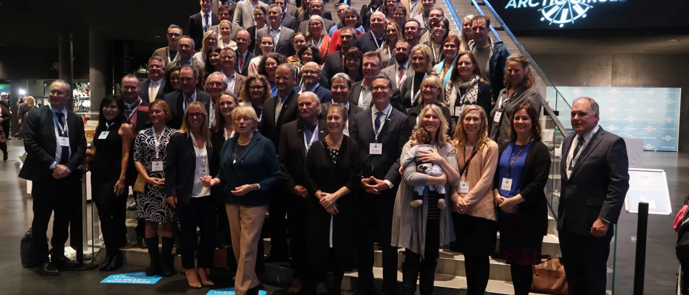 U N E community members stand with Maine's delegation at the 2019 arctic circle assembly