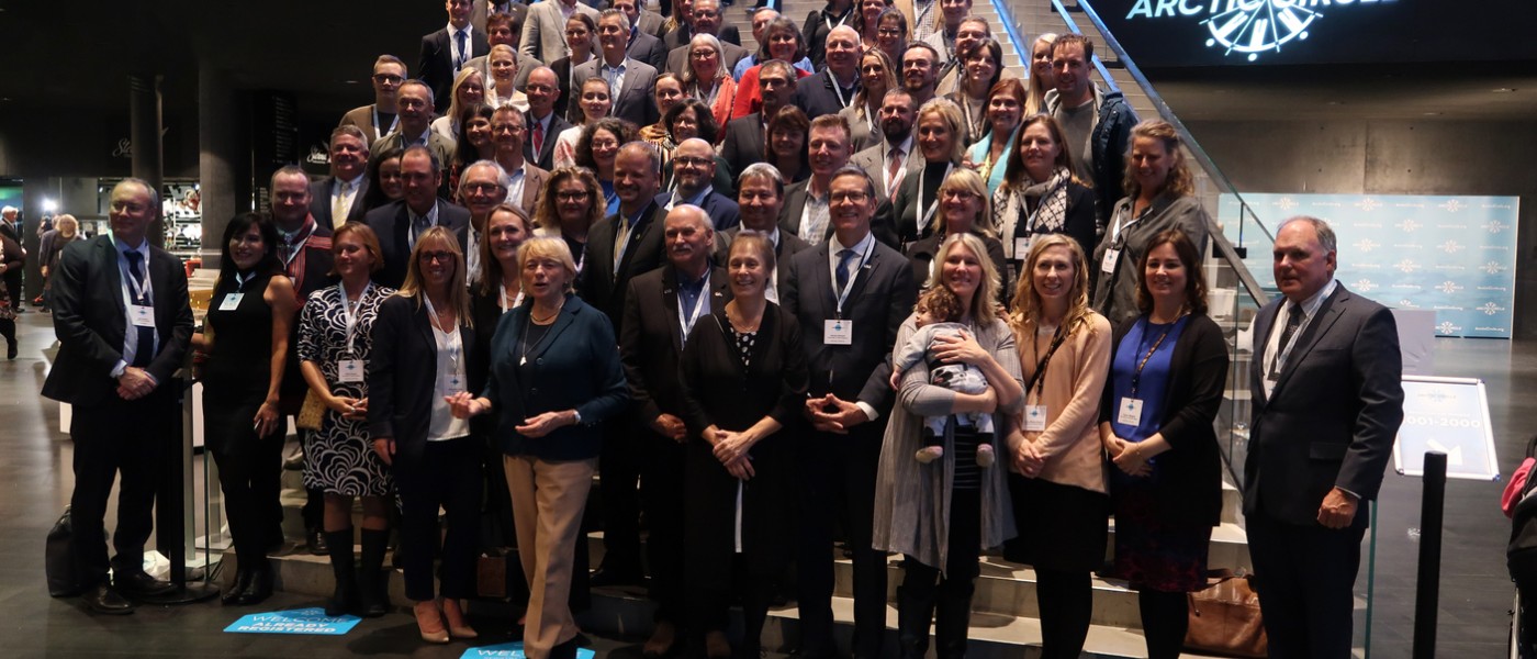 U N E community members stand with Maine's delegation at the 2019 arctic circle assembly