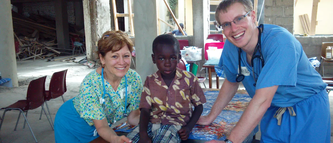 A Ghanaian boy sits upright after treatment from U N E clinicians
