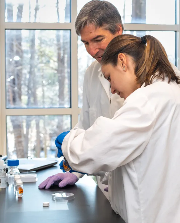 A student works with a professor on research