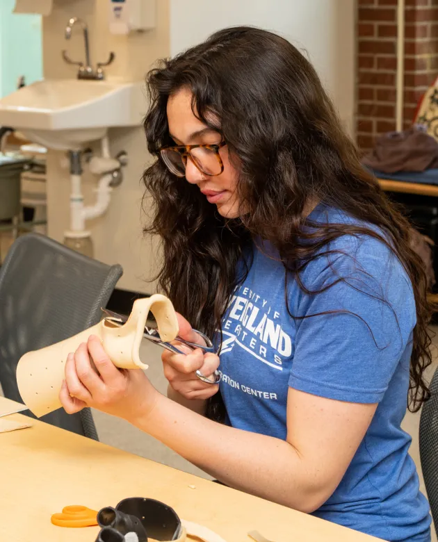 An occupational therapy student prepares a wrist splint from scratch