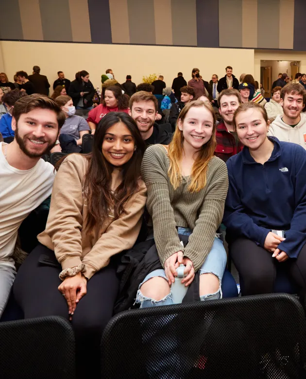 A group of students sit in the crowd of a lecture