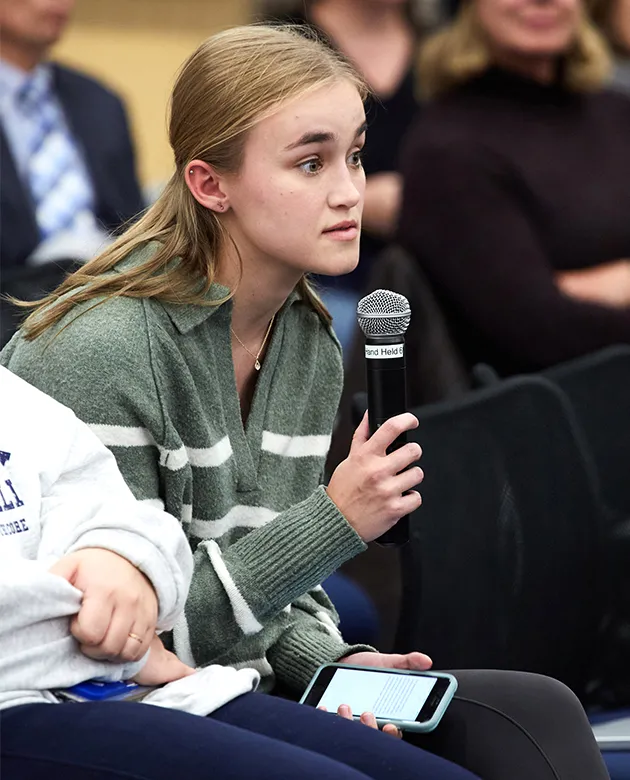 A UNE student poses a question on social media to the guest lecturers