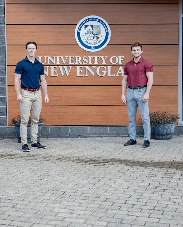 Stanizzi and Schuett pose in front of the Harold Alfond Forum