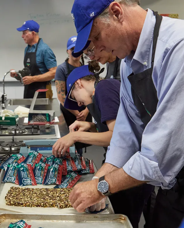 Cameron Wake prepares a seaweed bar to go into its packaging