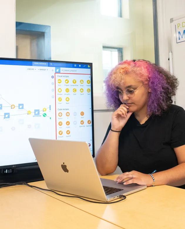 A student reviews data work on their laptop