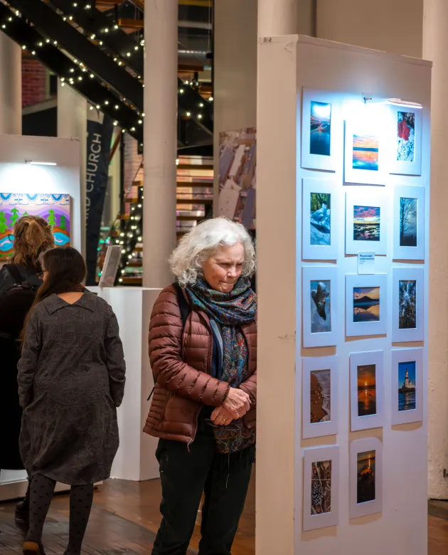 UNE Professor Pam Morgan views an art exhibit