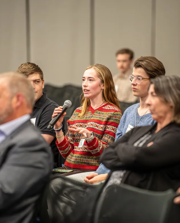 A student asks a question from the audience
