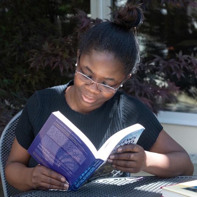 a student sits outside reading