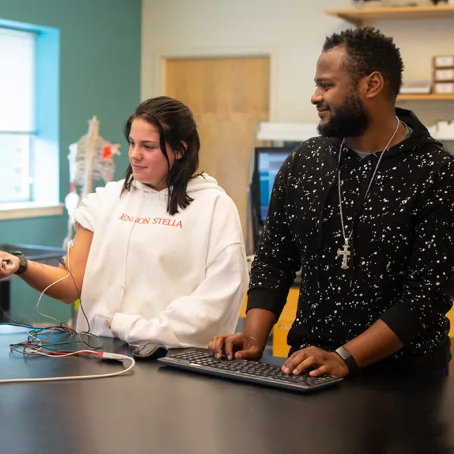 Two students perform an experiment in lab