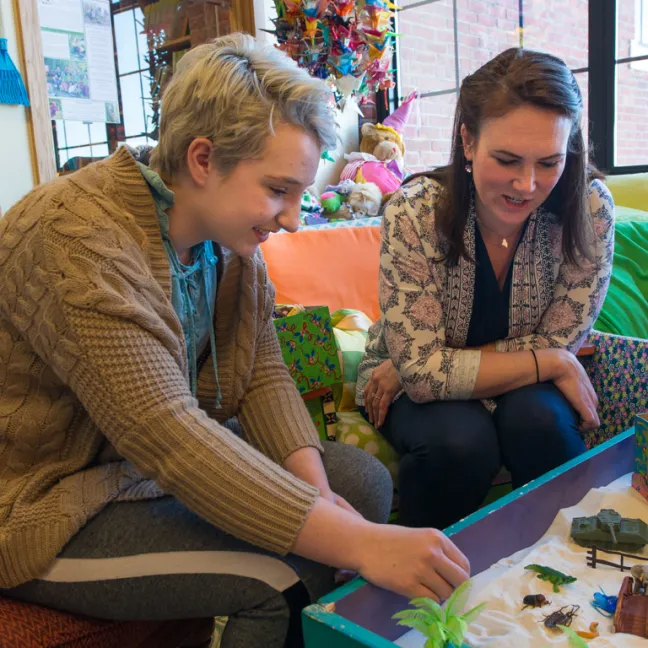 a student uses a sensory table to work with a patient