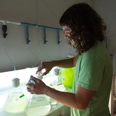 A student injects liquid into a beaker 
