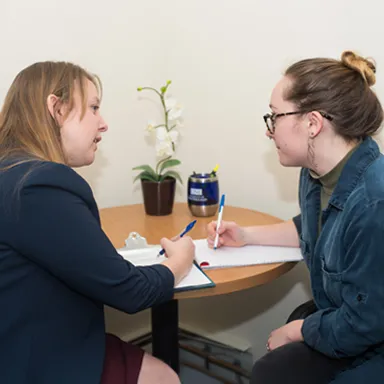 A student speaking with a staff member