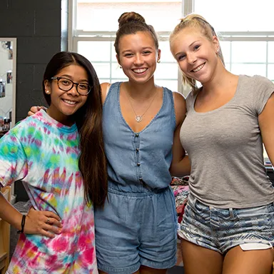 Three U N E students posing together