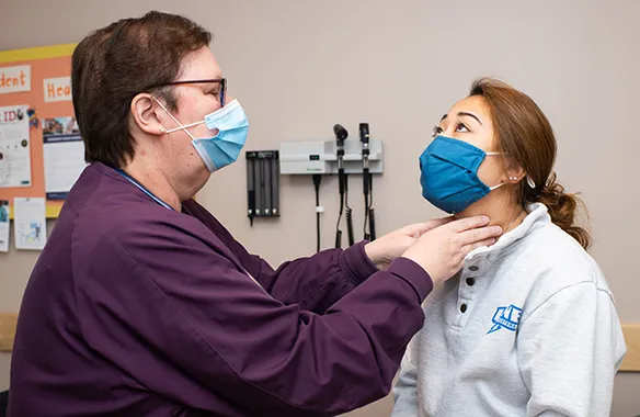 A U N E nurse doing a health check for a student