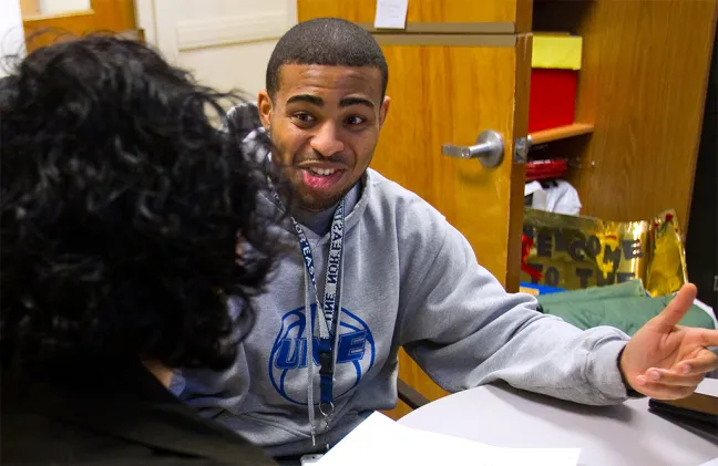 A student speaks to a staff member