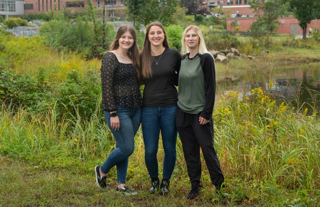 The three Davis Maine Scholarship winners stand in the grass