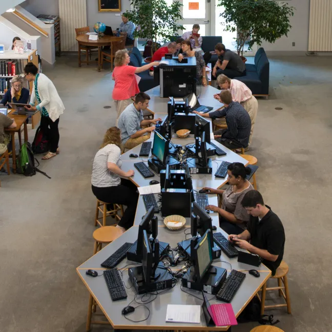 A view from the catwalk in the Portland campus library of students studying in the library