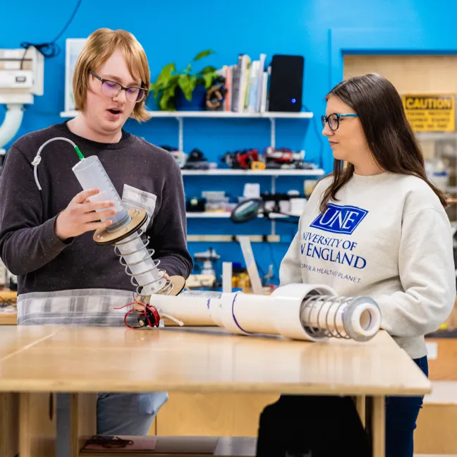 Two U N E students discuss a Makerspace project