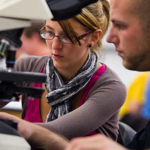 Two students working on a microscope lab project together