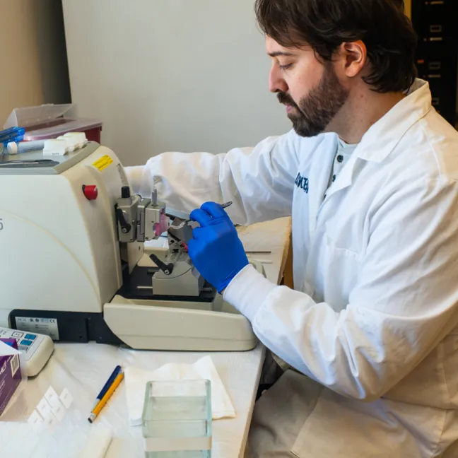 A research student uses lab equipment