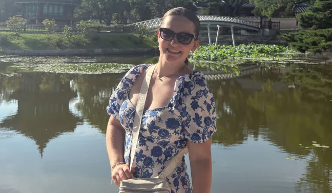Shauna Curran poses for a photo in front of a lake