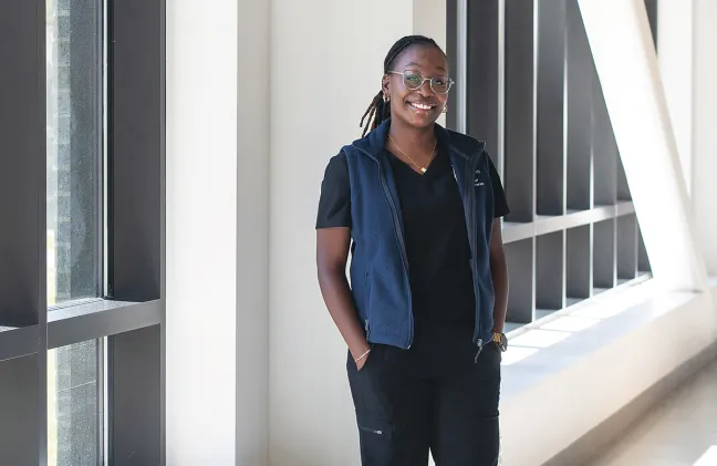 Vashti Etienne, a PT student, stands in the Harold and Bibby Alfond Center for Health Sciences
