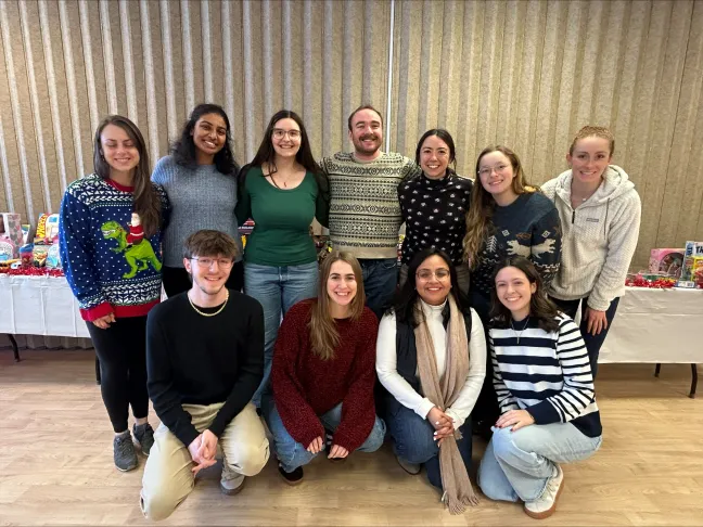 A group of students poses for a photo in UNE's Campus Center
