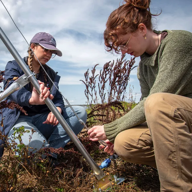 Two U N E students work outside
