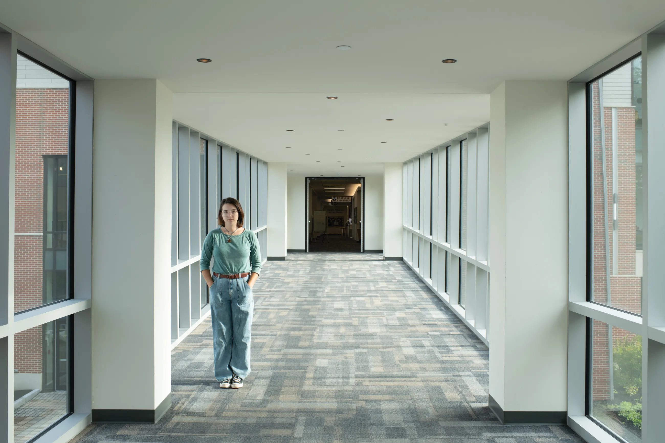Portrait of Virginia Grace May standing in a hallway