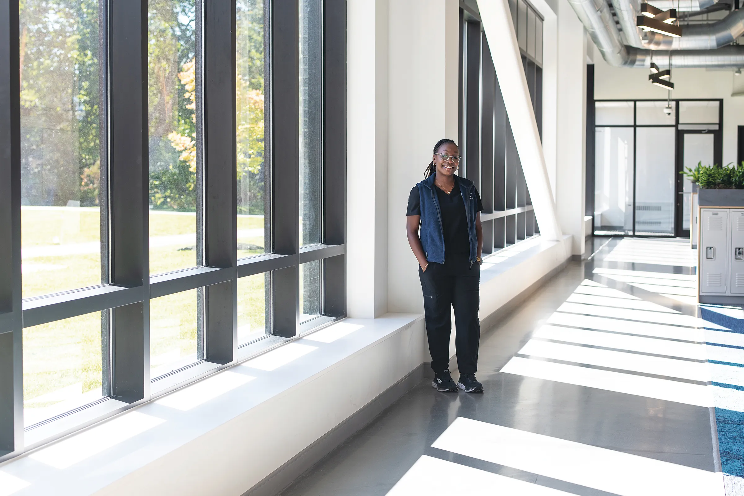 Vashti Etienne, a U N E physical therapy student, stands in the Harold and Bibby Alfond Center for Health Sciences