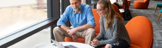 a faculty member helps a student study