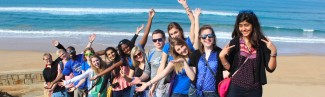 U N E students posing on the beach