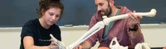 Two students examine a human bone