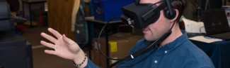 a u n e student uses virtual reality goggle
