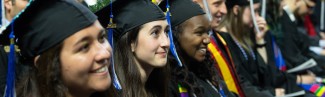 students sit at commencement