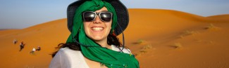 A student poses in the Sahara desert