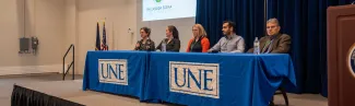 A group of interprofessional health care providers speaks to students as part of the conference