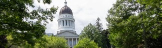 The dome of the Maine State House is pictured among the trees