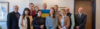 Members of a Ukrainian delegation pose with UNE President James Herbert and Associate Provost Mike Sheldon